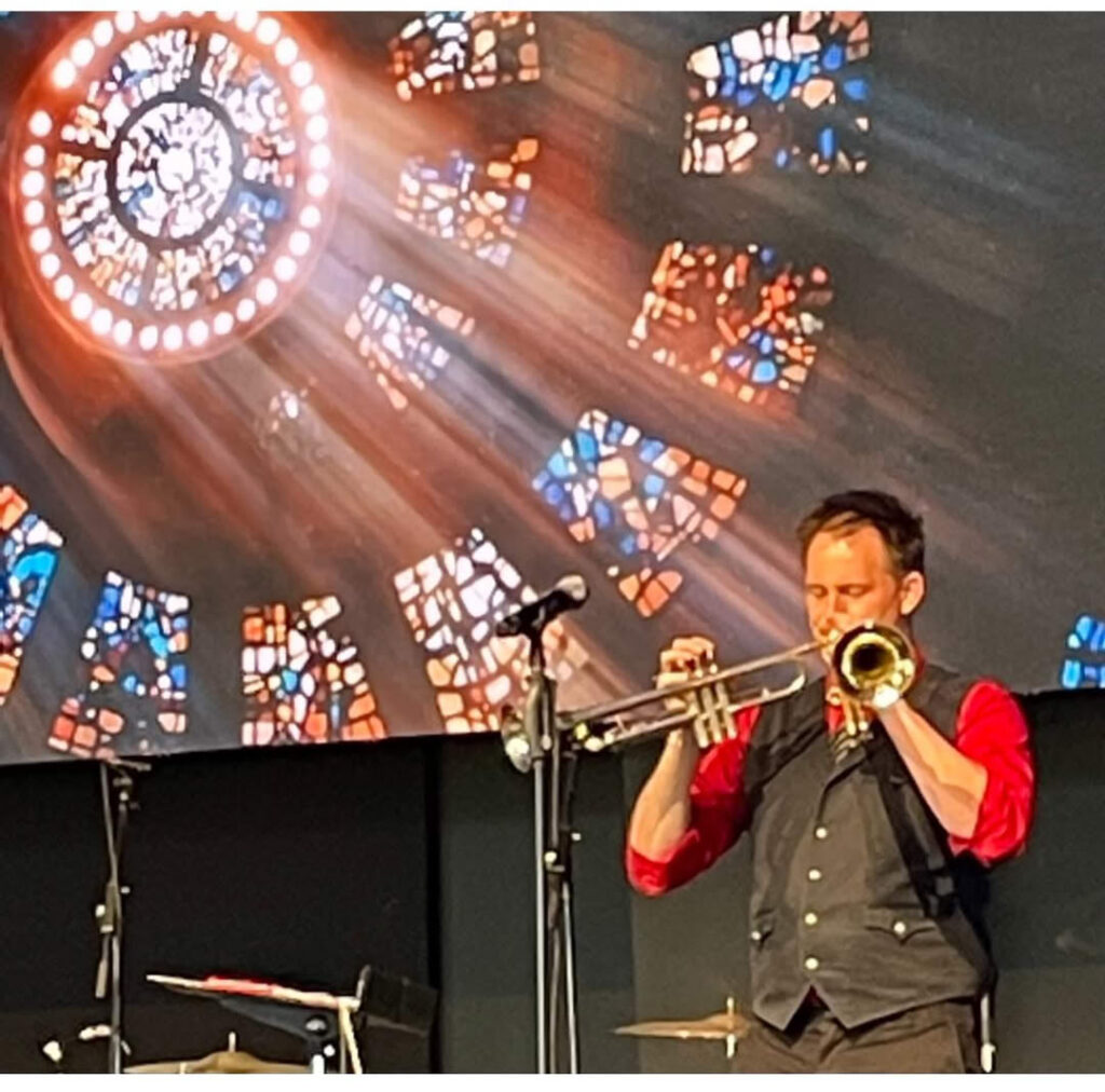 Denver playing 2 trumpets